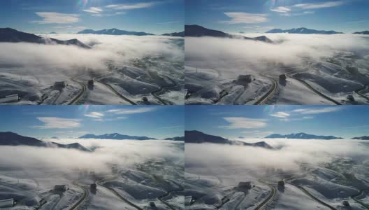 令人敬畏的航拍视频，蜿蜒的山路。无人机在云层中坠落高清在线视频素材下载