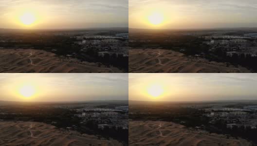 靠近新疆城市的沙漠鸟瞰图高清在线视频素材下载