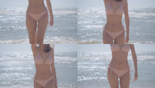 慢动作:特写身体比基尼漫步海边海滩苗条完美适合年轻的亚洲女子晒黑皮肤在热带休息和放松的旅行生活理念高清在线视频素材下载