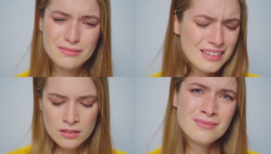 在工作室的灰色背景上，哭泣的女人摆出悲伤情绪的特写。高清在线视频素材下载