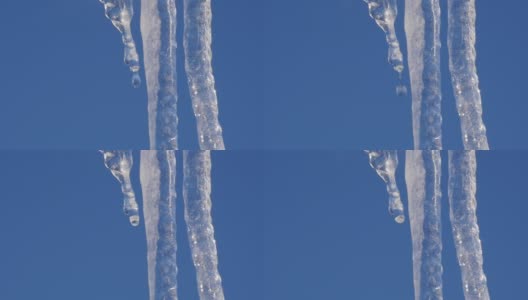 水滴从大冰柱上掉下来。阳光明媚的春天高清在线视频素材下载