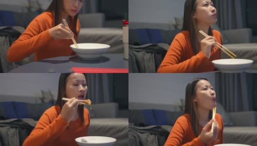 4K亚洲女人晚餐吃中国面条看电视电影高清在线视频素材下载