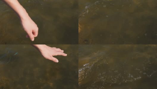近景上女人的手轻轻地触摸着水面的河水。女人的手让手指穿过水。慢动作全高清视频高清在线视频素材下载