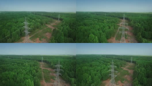 电力高压电替代能源输电铁塔延伸至森林。绿色生态森林。无人机的鸟瞰图。高清在线视频素材下载
