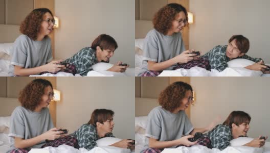 两个青少年在他们的房间里玩电子游戏。高清在线视频素材下载