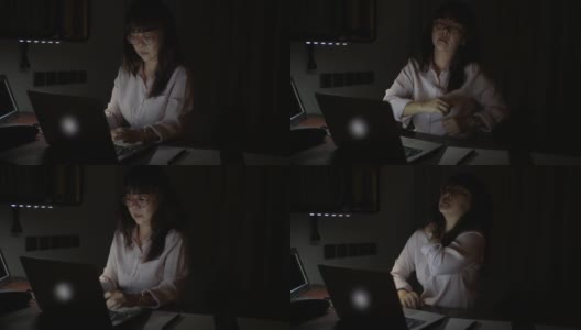 一个亚洲成熟的商业女性晚上独自坐在办公室里。高清在线视频素材下载