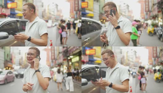 一名4K亚洲男子在泰国曼谷夜市街头使用智能手机旅行高清在线视频素材下载