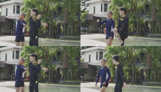 亚裔华人老人和他的儿子在游泳课前在泳池边热身高清在线视频素材下载