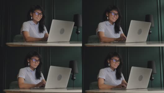笑容可掬的长头发女商人在笔记本电脑上高清在线视频素材下载