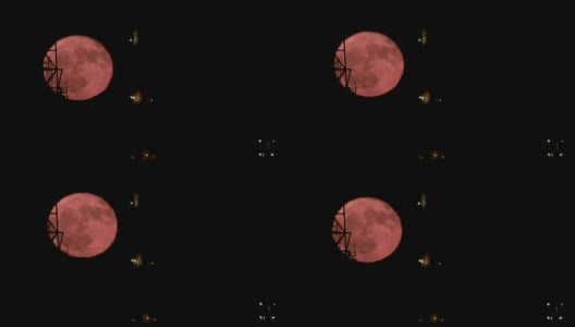 红色的满月从大型炼油厂后面升起高清在线视频素材下载