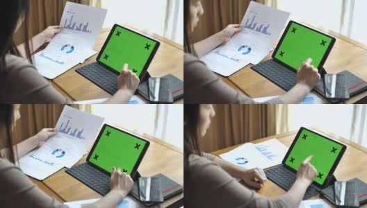 女性工作在数字平板电脑与图表，绿色屏幕高清在线视频素材下载
