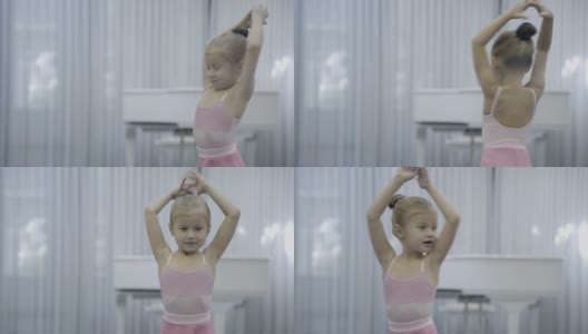 在芭蕾课上练习如何转身的举手女孩的肖像高清在线视频素材下载