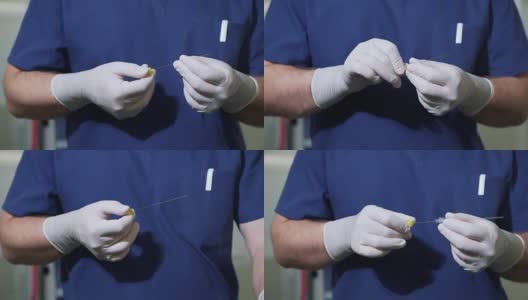 医生戴着消毒手套检查医疗设备。静脉曲张分流针。外科医生拿出一根大的金属针并将其缝合高清在线视频素材下载
