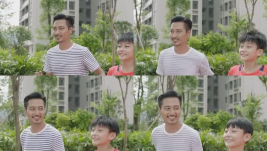亚洲父亲和儿子在花园跑步微笑彼此在慢镜头的特写高清在线视频素材下载
