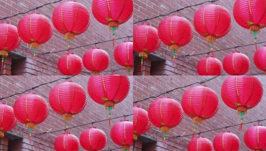 美丽的圆红灯笼挂在古老的传统大街上，是中国农历新年节日的概念。高清在线视频素材下载