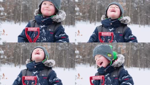 小男孩微笑和铲雪户外在冬季风暴高清在线视频素材下载