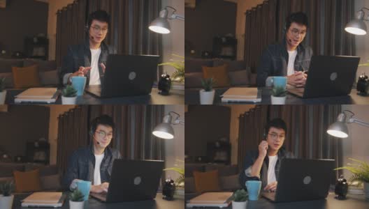 一名亚洲男子在家中使用笔记本电脑进行视频电话会议，工作到很晚高清在线视频素材下载