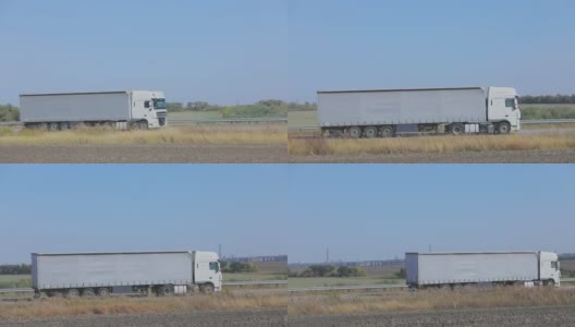 卡车在公路上行驶。卡车绕着田野和树林在公路上行驶高清在线视频素材下载