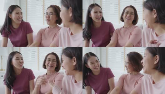 一群亚洲女人坐在一起谈笑风生在粉红戴乳腺癌。高清在线视频素材下载