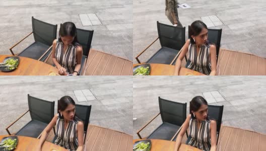 视频4 k。技术使用。业务人员。美丽的亚洲女商人戴着耳机在午餐休息时使用手机高清在线视频素材下载
