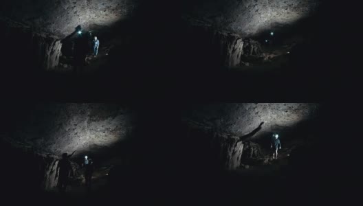 一群洞穴学家在黑暗的洞穴中行走高清在线视频素材下载