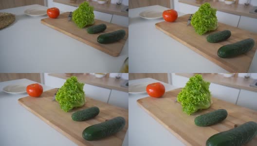 在时尚的厨房里拍摄切菜板上的新鲜蔬菜和厨房配件高清在线视频素材下载