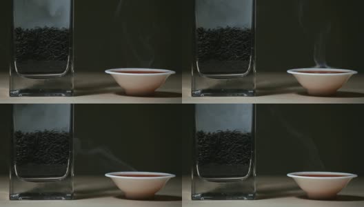 黑热的中国茶杯，木桌，黑色的背景，没有人高清的画面高清在线视频素材下载