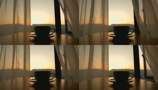在日出的背景下，咖啡杯放在桌上高清在线视频素材下载