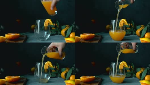 用手轻轻将陈年瓶中的橘子/橙汁倒入玻璃杯高清在线视频素材下载