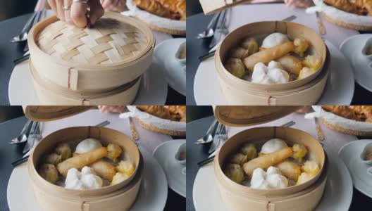年轻女子打开篮子里的饺子放在桌上点心，传统的中国饺子在传统的木篮子里高清在线视频素材下载