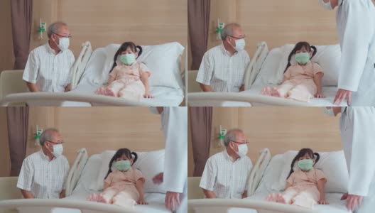 亚洲男医生带着口罩来到康复室，向躺在病床上的儿童病人询问健康问题。男医生检查心率、脉搏和提供健康保健咨询。高清在线视频素材下载