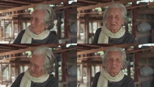 亚洲老年妇女的肖像，年长的妇女与短灰色头发坐在家里在泰国的农村，亚洲老年人在亚洲农村高清在线视频素材下载