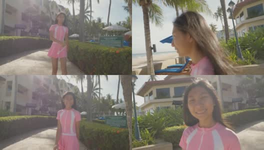 亚洲女孩穿着泳装，在酒店度假时走在去海滩的路上，生活方式的概念。高清在线视频素材下载