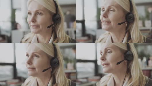 中年女商务经理，戴着耳机在办公室里说话，在网上提供建议高清在线视频素材下载