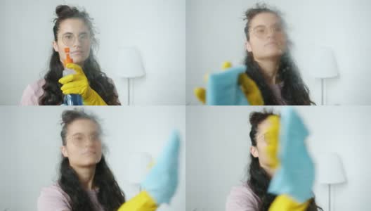女清洁工的肖像转向相机在家里喷洒水和清洗高清在线视频素材下载