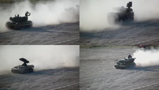 俄罗斯现代化坦克和装备纵队沿着尘土飞扬的道路行进。高清在线视频素材下载