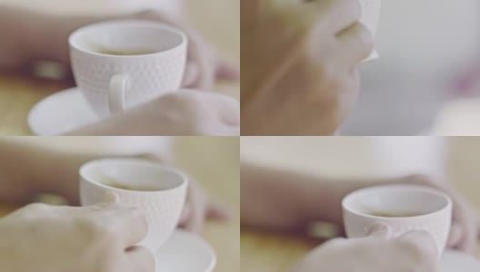 中年妇女双手捧着一杯咖啡放在桌上高清在线视频素材下载