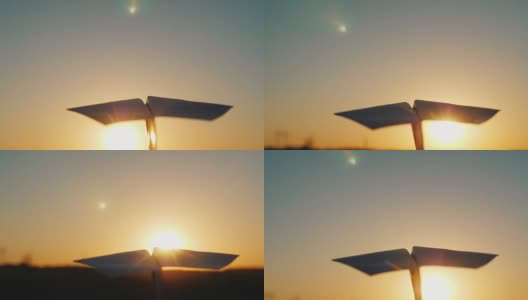 一架纸飞机在天上飞着迎接夕阳。观点视频高清在线视频素材下载