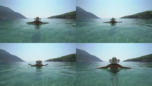 戴着帽子的中年妇女，在海边休息。Marmaris土耳其高清在线视频素材下载