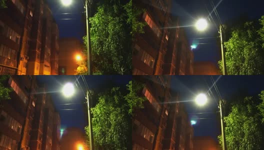 在夜晚的街道上，点燃和熄灭的路灯高清在线视频素材下载