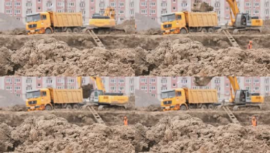 挖掘机用铲斗将粘土装入自卸卡车高清在线视频素材下载