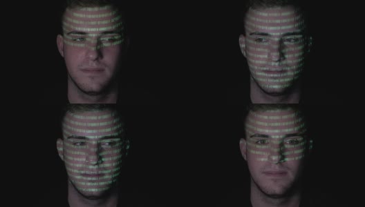 运行着绿色程序代码的人脸上折射着一个年轻冷静的男性电脑黑客高清在线视频素材下载