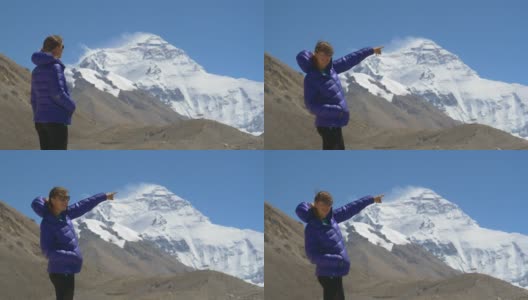 肖像:年轻的徒步旅行者兴奋地从风景优美的大本营指向珠穆朗玛峰。高清在线视频素材下载