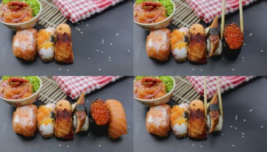 日本食品成分。各种寿司放在黑板上。辣泡菜三文鱼色拉配筷子。高清在线视频素材下载