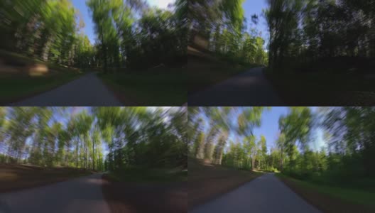 在森林柏油路上骑自行车的广角POV超延时高清在线视频素材下载