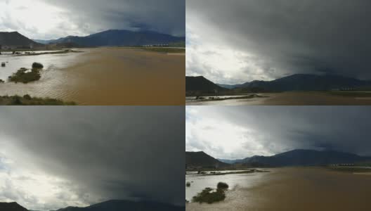 四千条拉萨河，远处黑云团翻滚在西藏山顶。高清在线视频素材下载