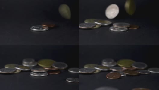 硬币落在黑色背景上高清在线视频素材下载