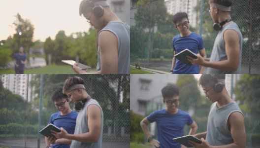2名亚洲中国少年用电子平板电脑准备锻炼。高清在线视频素材下载