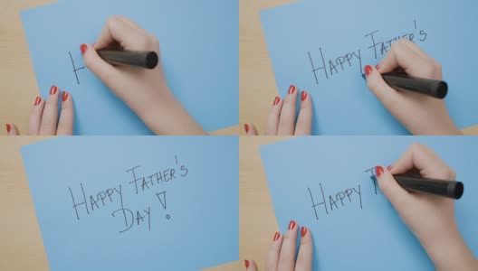 女孩用红指甲在蓝色的纸上写父亲节快乐高清在线视频素材下载