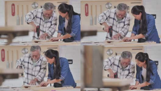工人木匠老人70岁和十几岁的女孩与他的司钻一起在工厂制作木制家具。工厂和制造概念。高清在线视频素材下载